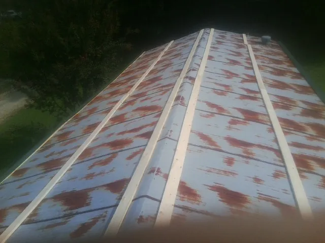 Rusted metal roof panels with new wood purlins before replacement — Storm Damage Roof Repair in Laughlin by Roofing Brothers