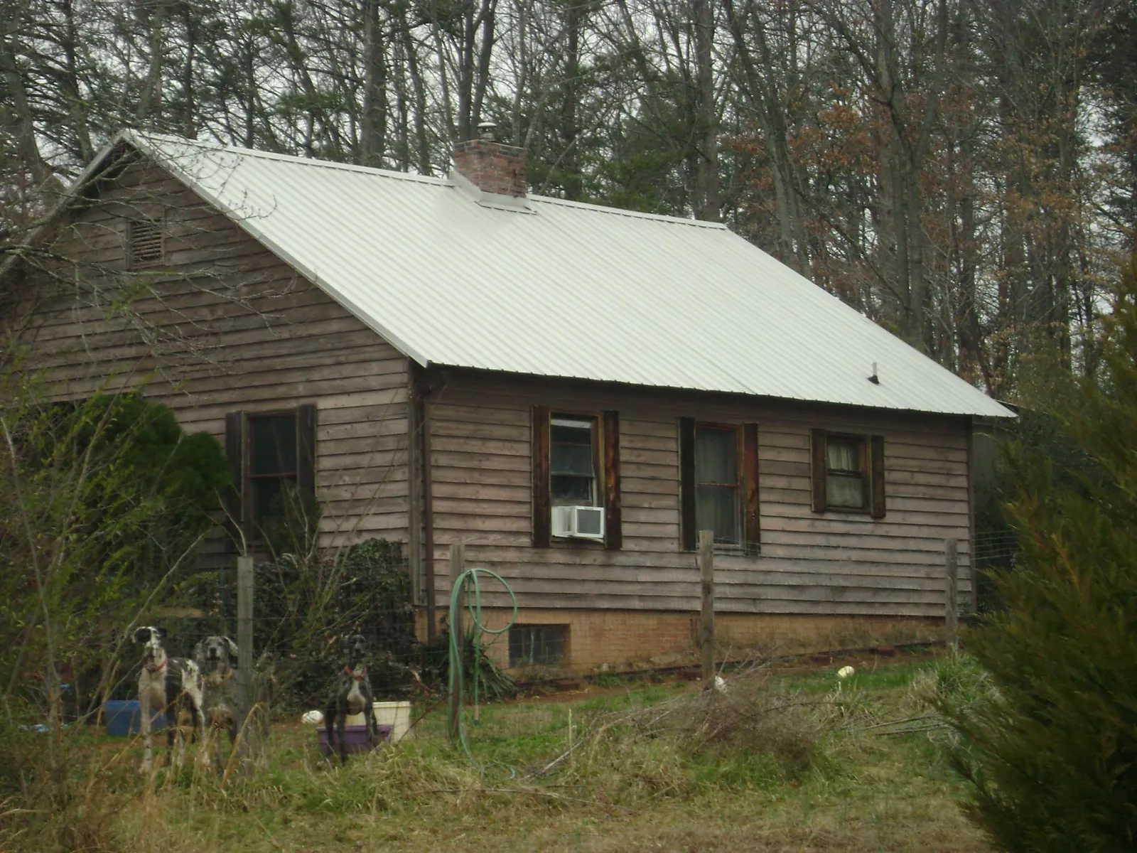 White metal roof on an old wood sided farmhouse, from a Metal Roof Installation job in Laughlin